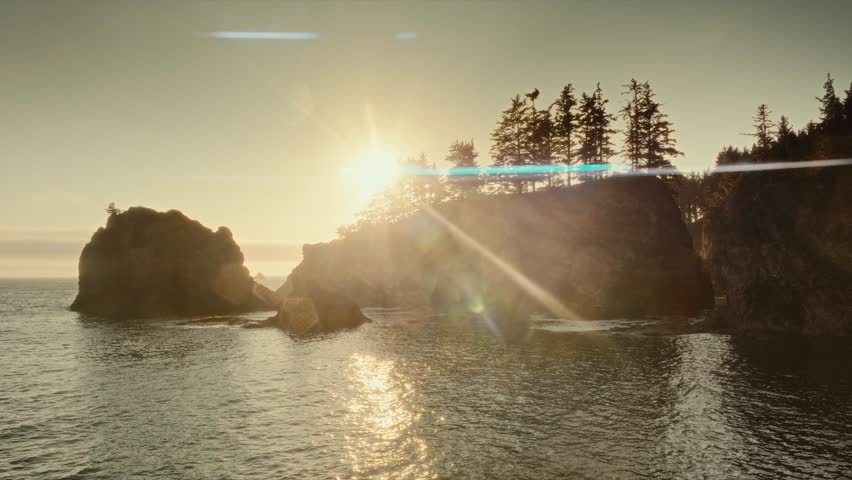 4K Drone shot low sun, tree silhouettes over Samuel Boardman State Scenic Corridor, Oregon breathtaking, secluded coastal dramatic cliffs, rugged shoreline. Oregon’s picturesque, secretive coast.
