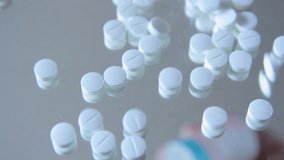Hand pouring pills from a box onto a mirrored surface - Powered by Shutterstock - Get 15% off with code: PIKWIZARD15