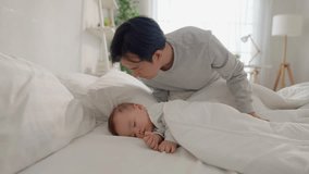 Asian loving father putting blanket on sleeping baby boy with gently. Attractive parent look after young son infant toddler lying down and resting comfortably, sleep for early childhood development. - Powered by Shutterstock - Get 15% off with code: PIKWIZARD15