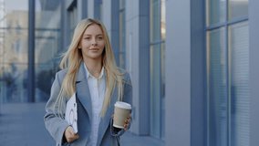 Joyful and Accomplished Office Employee Heads Home After Workday, Clutching Work Documents, Drinking Coffee. Young Female Boss Going to Office while Coffee Break, Holding Charts. Business and People - Powered by Shutterstock - Get 15% off with code: PIKWIZARD15