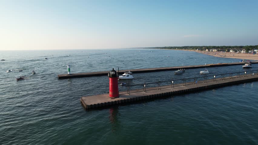 Aerial view of the light house of south haven beach with boats in lake michigan