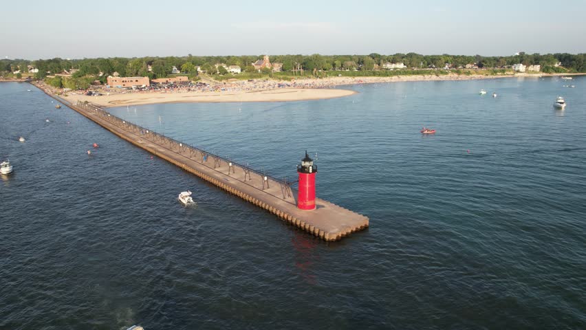 Aerial view of the beach filled with people on a hot sunny day in Lake Michigan, South Haven, Michigan with Lighthouse