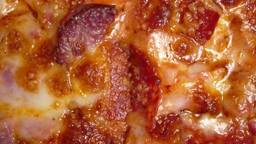 Savoring a delicious pizza topped with salami and mozzarella cheese