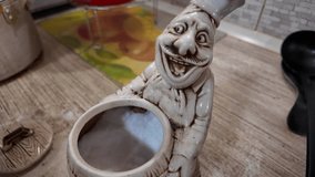 unusual salt shaker in the form of a chef. salt shaker in the kitchen. salt shaker figurine. Glass shakers on the kitchen table in the restaurant kitchen. glass shakers for salt and pepper  - Powered by Shutterstock - Get 15% off with code: PIKWIZARD15