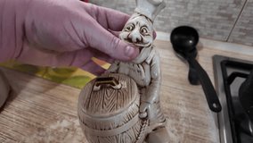 unusual salt shaker in the form of a chef. salt shaker in the kitchen. salt shaker figurine. Glass shakers on the kitchen table in the restaurant kitchen. glass shakers for salt and pepper  - Powered by Shutterstock - Get 15% off with code: PIKWIZARD15