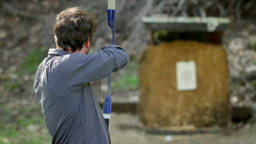 Archery seen from over the archer's shoulder. Shot with telephoto lens and rack