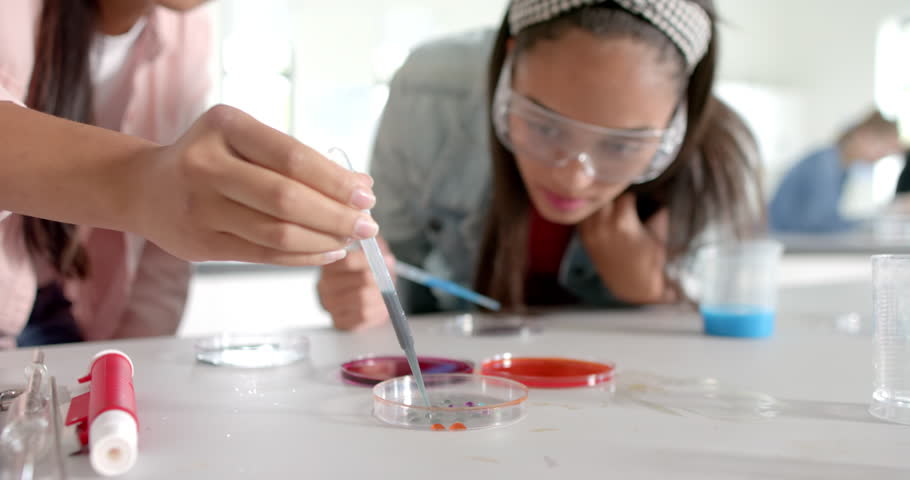 In high school, teenagers conducting science experiment with petri dishes and pipette. laboratory, biology, chemistry, research, education, students
