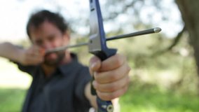 Archer viewed from the front with focus on the arrow tip. Clip doesn't change focus.