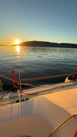 Yacht sailing in Adriatic sea. Close-up view of the deck, mast and sails at sunset light. Yachting concept. High quality 4k footage