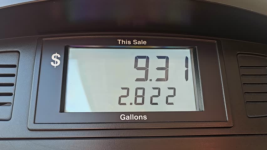Gas Pump Display Showing Price and Gallons, Close-up of a gas pump screen displaying the total cost and gallons pumped