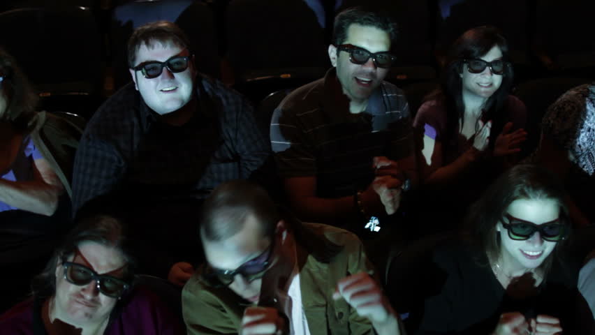 Audience gets excited at a 3D movie screening. Camera moves on a jib and moving