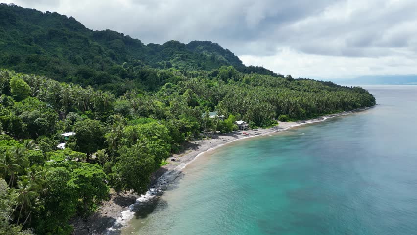 The serene atmosphere of the beachfront on Savo Island in the Solomon Islands, with pristine sands and gentle waves.
