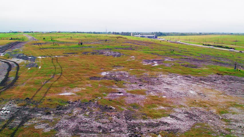 A marshy landfill near New Orleans, Louisiana, featuring active gas wells extracting methane for sustainable energy and responsible waste management.