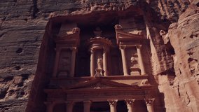 The Treasury (Al-Khazneh) ancient tomb rock cut sculpture facade, Petra, Aerial ascending - Powered by Shutterstock - Get 15% off with code: PIKWIZARD15