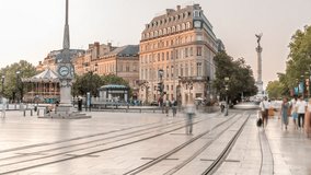 Triangular building and modern tram at Place de la Comedie timelapse, Bordeaux, France, during sunset. Shadow move across the facade and a streetlight with a clock adds elegance to this urban landmark - Powered by Shutterstock - Get 15% off with code: PIKWIZARD15