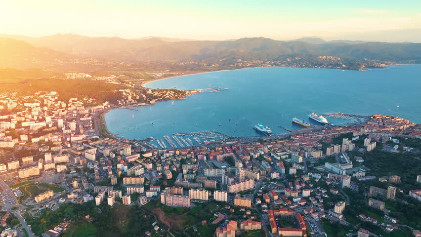Cruise ships docked in Ajaccio, Corsica with stunning coastal views during sunset
