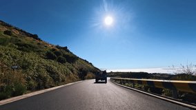 Rolling shot of an off-road pickup truck car driving on a scenic mountain road above the clouds. Group of friends on an adventure road trip in Madeira Island  - Powered by Shutterstock - Get 15% off with code: PIKWIZARD15