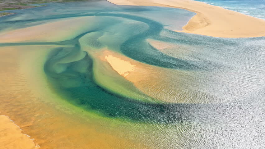 Sunny golden beach surrounded by green mountains blue water resort vacation ocean coast