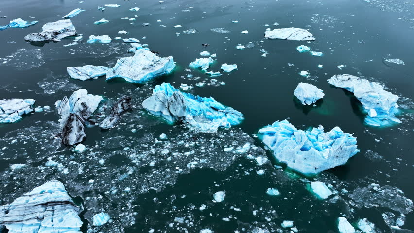 Icebergs Huge Chunks of Blue Glacier Ice Floating Arctic Nature in Iceland Ocean Aerial View