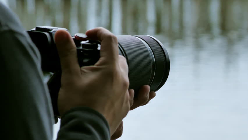 Photo camera shoot scene, handheld, close-up, cameraman, video camera, photographer videographer filming outdoors, filming camera, recording camera, production, director