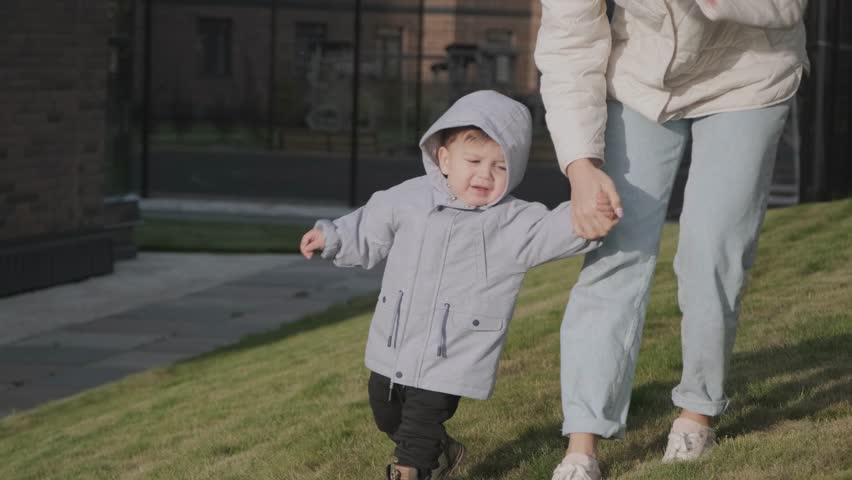 Baby with mother on a walk in autum time
