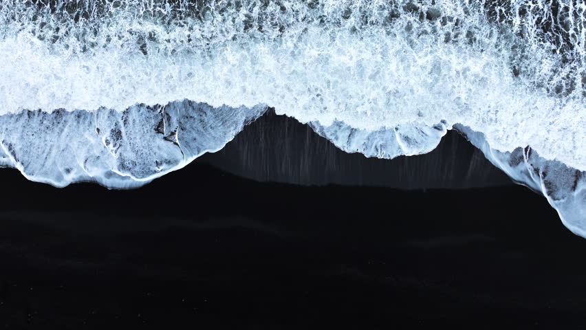 Black sand beach with crashing waves, Serene and tranquil landscape, Ocean coast with calm waves, Famous landmark of Iceland, Black sand of volcanic origin aerial view