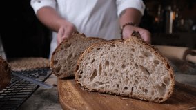 Hands of an Artisan Baker Presenting Freshly Baked Rustic Sourdough Bread with Perfect Golden Crust - Powered by Shutterstock - Get 15% off with code: PIKWIZARD15