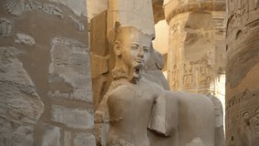 Egyptian statue of a pharaoh near columns in a ruined temple - Powered by Shutterstock - Get 15% off with code: PIKWIZARD15