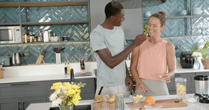 diverse couple in kitchen laughing and preparing healthy fruit snacks together, copy space. Lifestyle, happiness, cooking, home, fruits, relationship - Powered by Shutterstock - Get 15% off with code: PIKWIZARD15