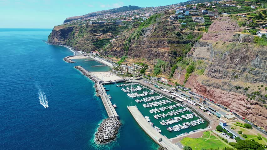 Aerial view of the beach and harbor in Calheta, Aerial view of the cliff near Calheta, a municipality on the southwest coast of the Portuguese island of Madeira
