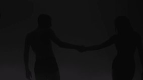 Modern ballet dancers performing together on dark stage. Silhouette of couple of performers with smoke in the air. - Powered by Shutterstock - Get 15% off with code: PIKWIZARD15