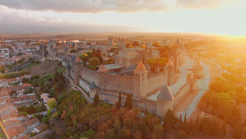 Aerial view of the medieval city of Carcassonne town and its fortress castle at sunrise, southern France.Famous historic fortress with its iconic medieval towers in the beautiful morning light