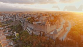 Aerial view of the medieval city of Carcassonne town and its fortress castle at sunrise, southern France.Famous historic fortress with its iconic medieval towers in the beautiful morning light - Powered by Shutterstock - Get 15% off with code: PIKWIZARD15