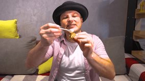 A young man in a hat appetizingly eats a sweet dessert, eating a wafer roll with chocolate and drizzled with honey. Slow motion. - Powered by Shutterstock - Get 15% off with code: PIKWIZARD15