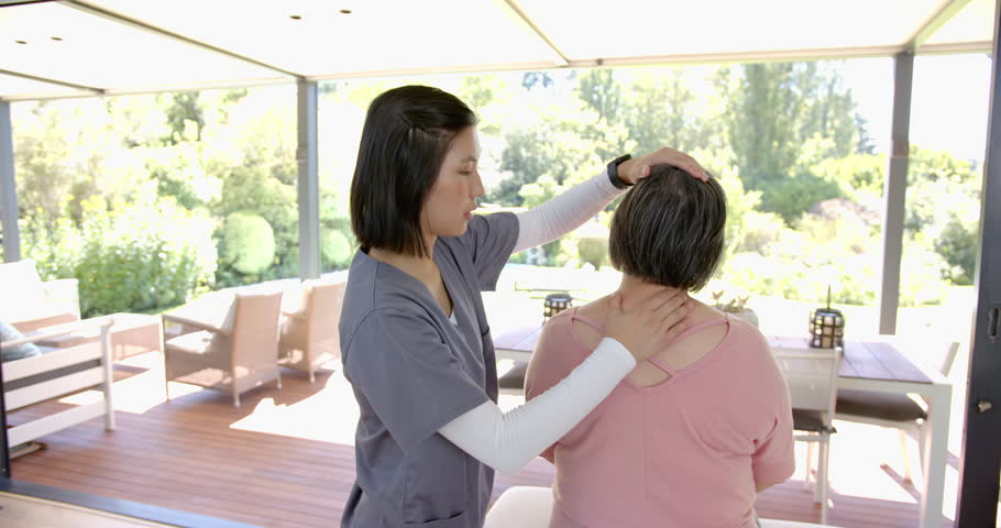 Providing physical therapy, female therapist assisting senior asian woman with neck exercises. Healthcare, rehabilitation, physiotherapy, assistance, wellness