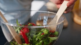 Chief hands mixing salad preparing food at cozy kitchen closeup. Carefree cheerful guy preparing vegetables cooking at light apartment. Smiling brunette making tasty meal alone. Culinary concept  - Powered by Shutterstock - Get 15% off with code: PIKWIZARD15