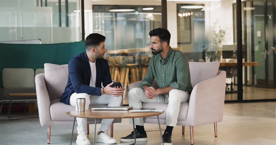 Man demonstrating new AI business application on smartphone to colleague, explains or showing information related to work tasks, data, or project updates, review mobile app, presenting online content