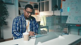 African American programmer works in an office, typing code on futuristic screen - Powered by Shutterstock - Get 15% off with code: PIKWIZARD15