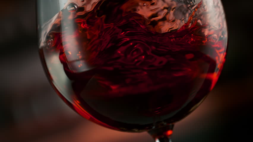 Super Slow Motion Detail Shot of Spinning Red Wine in Glass at 1000fps.