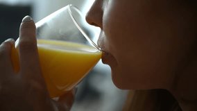 A closeup of a joyful woman enjoying refreshing orange juice, highlighting her health and vitality - Powered by Shutterstock - Get 15% off with code: PIKWIZARD15