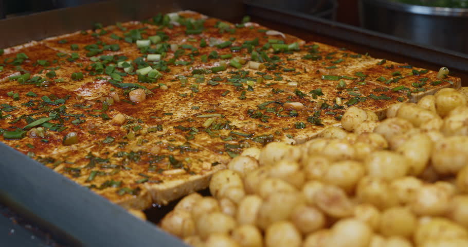 Fried Tofu With Green Onions And Spices. Street Food In China. Tofu Or Doufu Is Bean Curd. Traditional Component Of Many East Asian And Southeast Asian Cuisines. Tofu Originated In China And Has Been