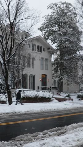 Person Walking Down the DC Street in the Snow