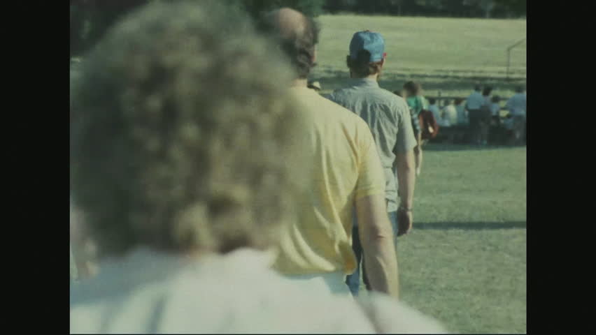 UNITED STATES 1970s: Tourists walking on grounds of Gettysburg in summer looking at monuments. State of Pennsylvania monument from distance and close-up details.