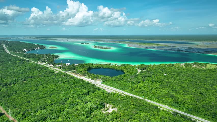 Drone shot of Bacalar lagoon of seven colors, cenote, Scenic driving through coastal landscape, Quintana Roo