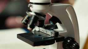 African american scholar studies medical science in a college library, doing research on viruses using a microscope. Girl works on exam preparation for success in a scientific career. Camera B. - Powered by Shutterstock - Get 15% off with code: PIKWIZARD15