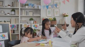 Parent and children enjoying a creative session together, showcasing the joy of learning, family interaction, and artistic expression in a nurturing and peaceful environment. - Powered by Shutterstock - Get 15% off with code: PIKWIZARD15