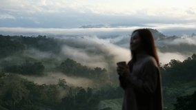Blurred of a woman drinking coffee and looking at a beautiful mountain views on foggy day - Powered by Shutterstock - Get 15% off with code: PIKWIZARD15