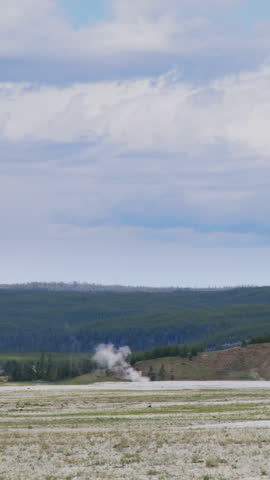 A breathtaking and stunning view of the natural geysers and lush, vibrant landscapes found in Yellowstone National Park, located in the heart of Wyoming, showcasing the true beauty of nature