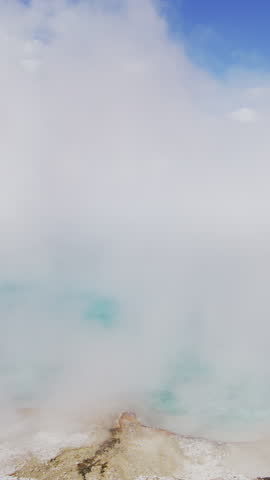 Experience a stunning view of steam gracefully rising from the geothermal features found in Yellowstone National Park, perfectly showcasing the incredible beauty of nature in all its glory
