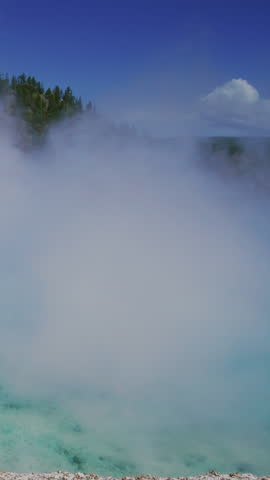 Yellowstone National Park offers stunning views with vibrant colors and steam from unique geothermal features, creating an unforgettable scene for visitors to cherish long after their visit
